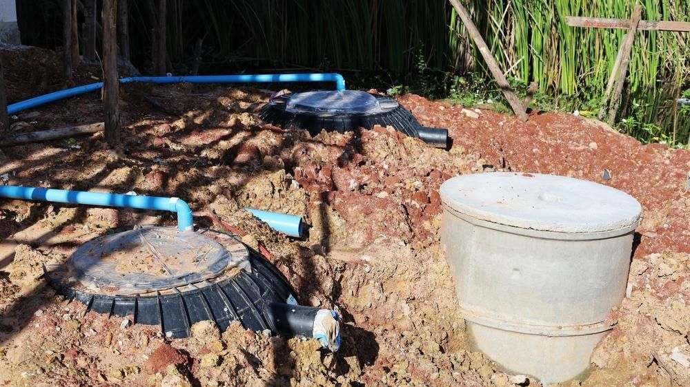 A Septic Tank Is Sitting In The Middle Of A Dirt Field — Gympie Septic Pump Outs In Pomona, QLD