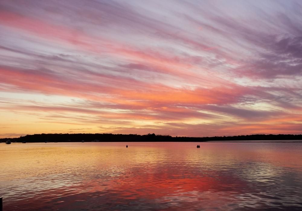 A Sunset Over A Body Of Water With A Colourful Sky — Gympie Septic Pump Outs In Tin Can Bay, QLD