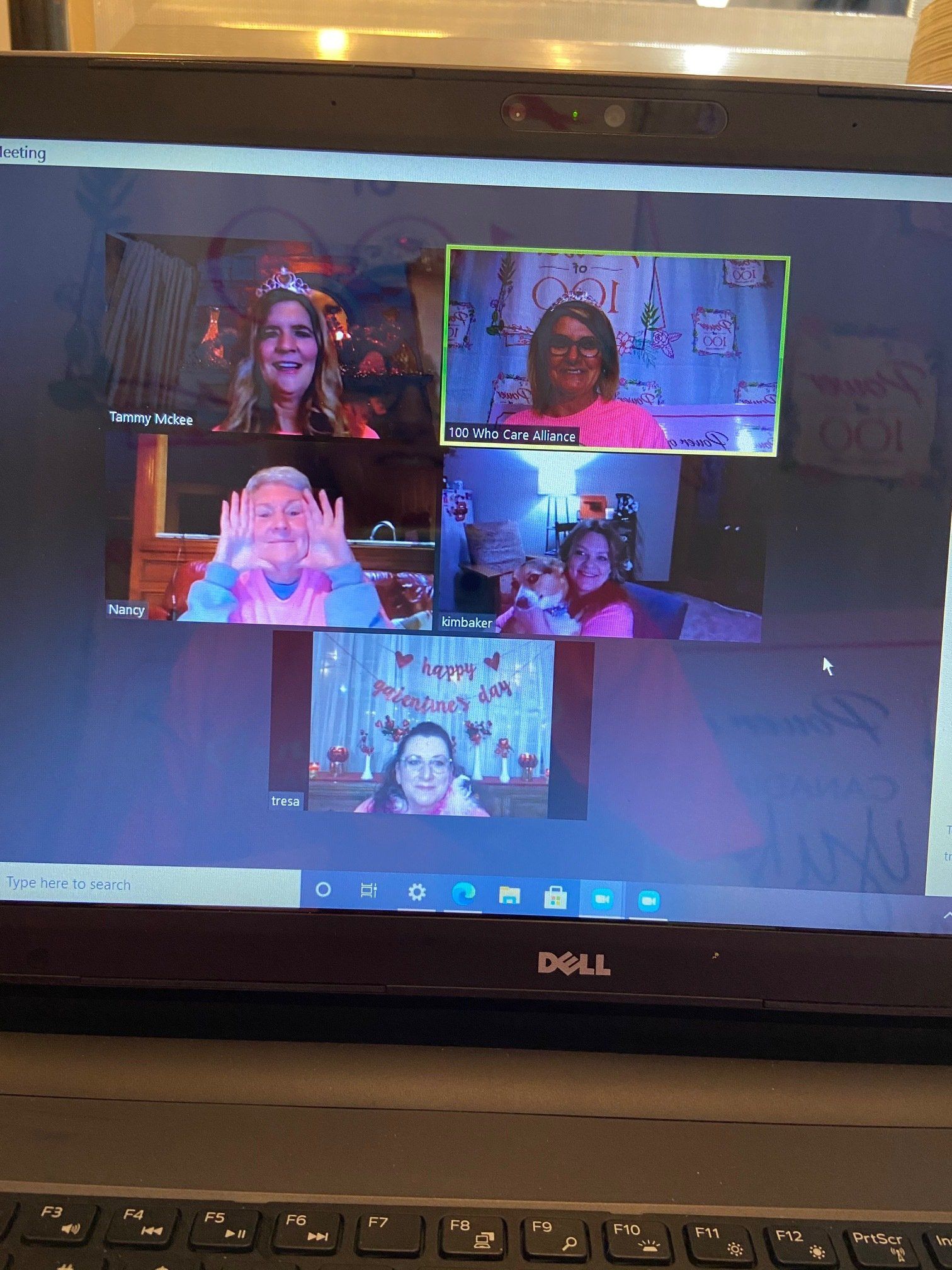 A group of people are having a video call on a dell laptop