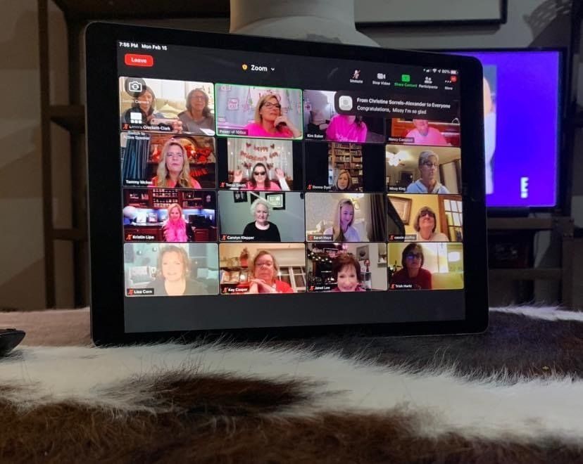 A group of people are having a video call on a tablet