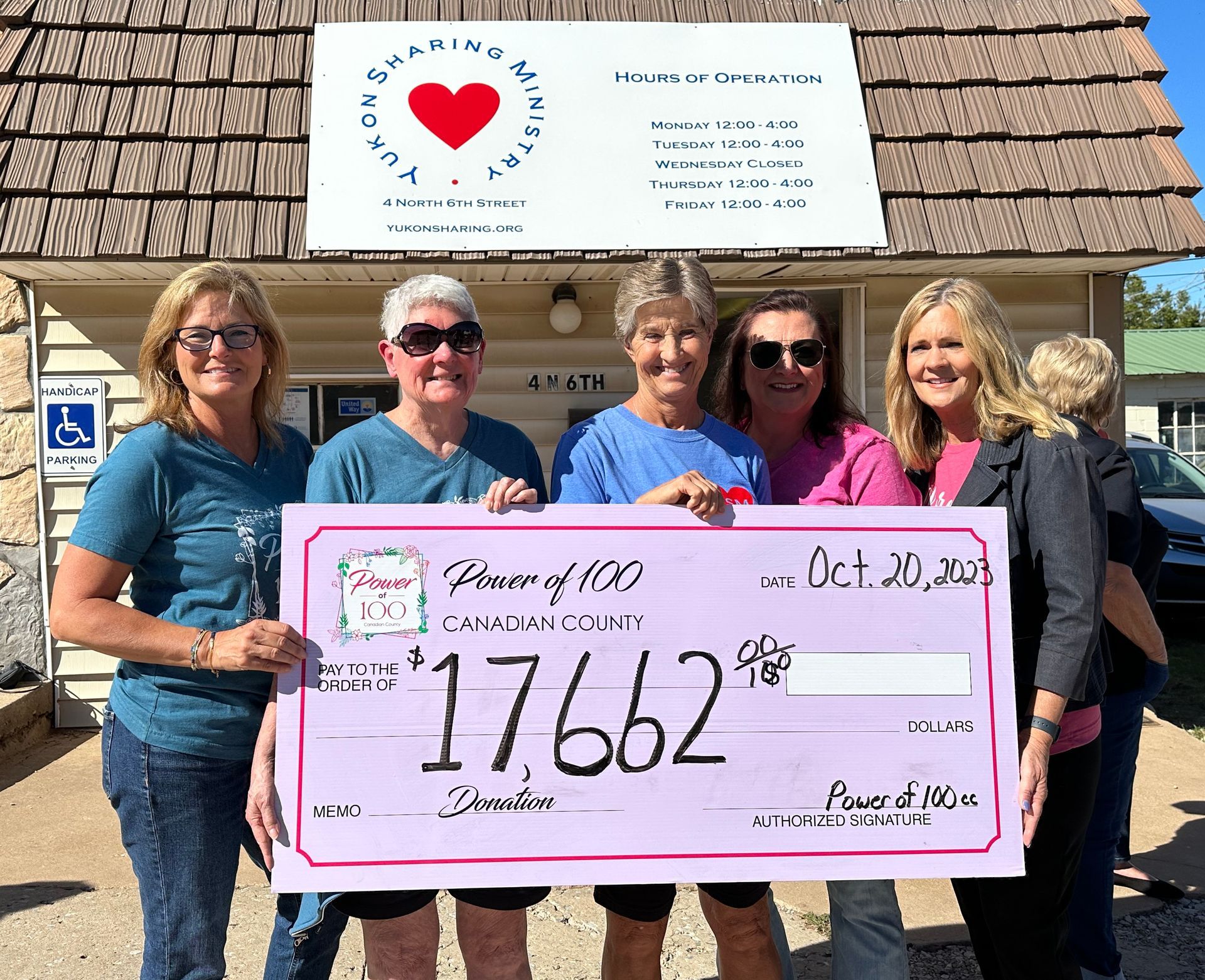 A group of women are holding a check that says 17662 on it.