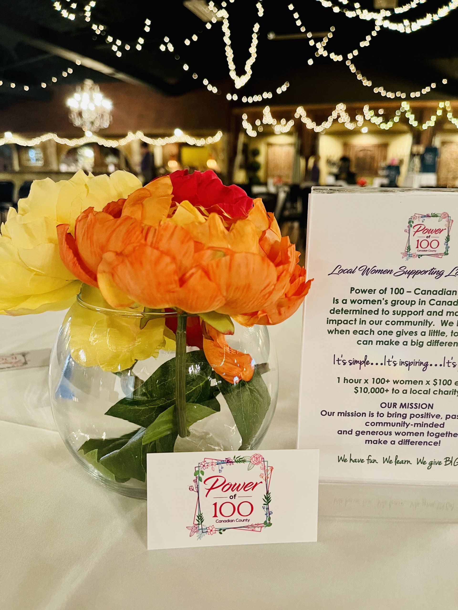 A vase filled with flowers and a sign that says flower 100
