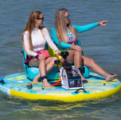Family boarding a white boat at a marina beside modern waterfront buildings
