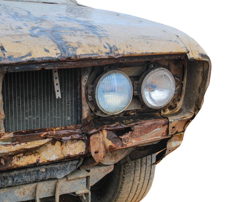 A Close Up Of The Front Of An Old Rusty Car — Lyons Street Paint Panel in Cairns, QLD