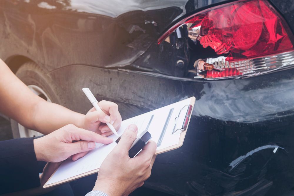 Insurance Agent Working On Car Accident — Lyons Street Paint Panel in Bungalow, QLD