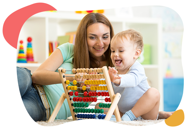 A woman and a baby are playing with an abacus.