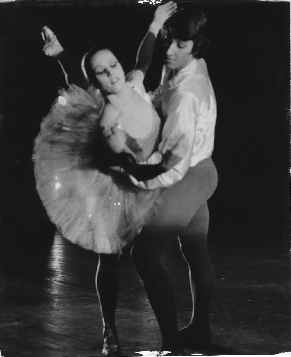 A black and white photo of a man and a woman dancing