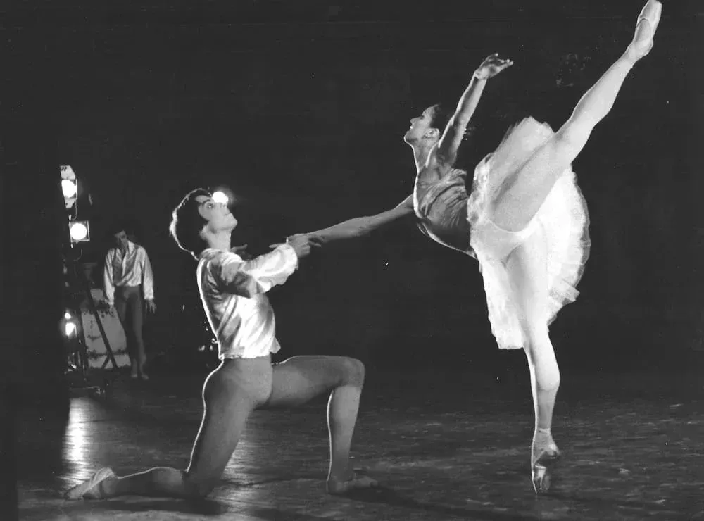 A black and white photo of a man and a woman dancing