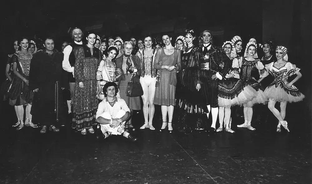 A black and white photo of a group of people posing for a picture
