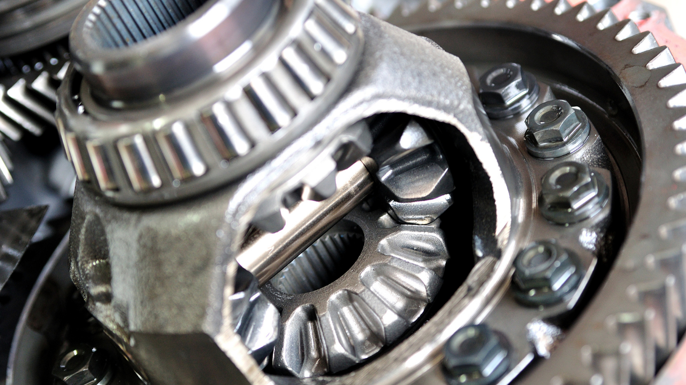 Close-up of shiny metal gears and bearings inside a mechanical assembly