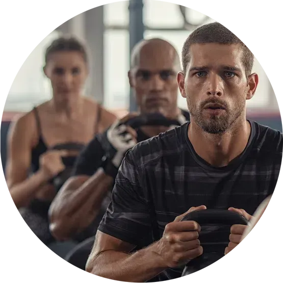 A group of people are doing exercises in a gym