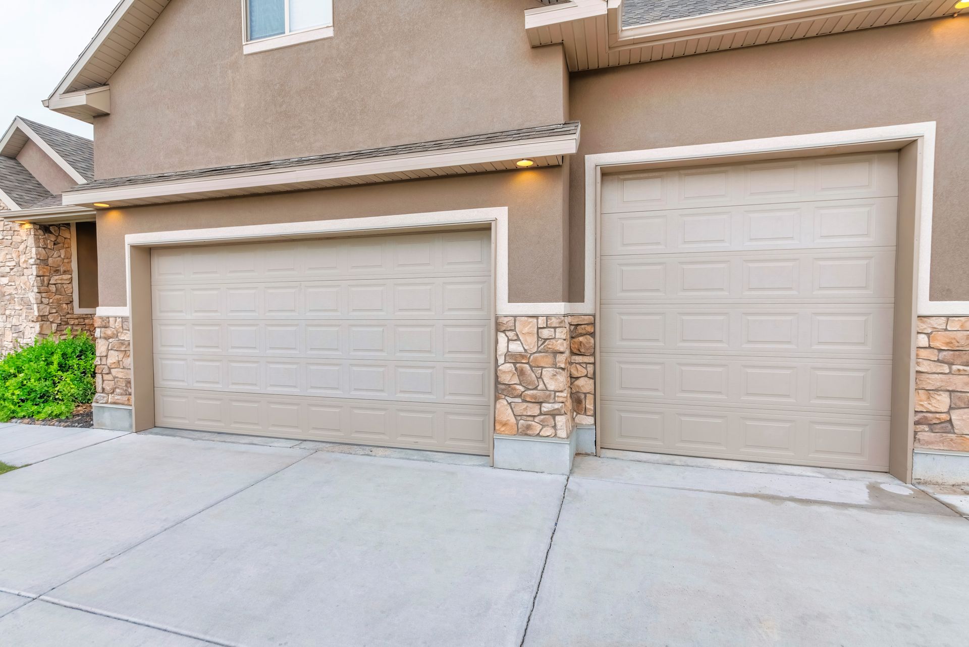 Home with stone accent walls and a concrete driveway