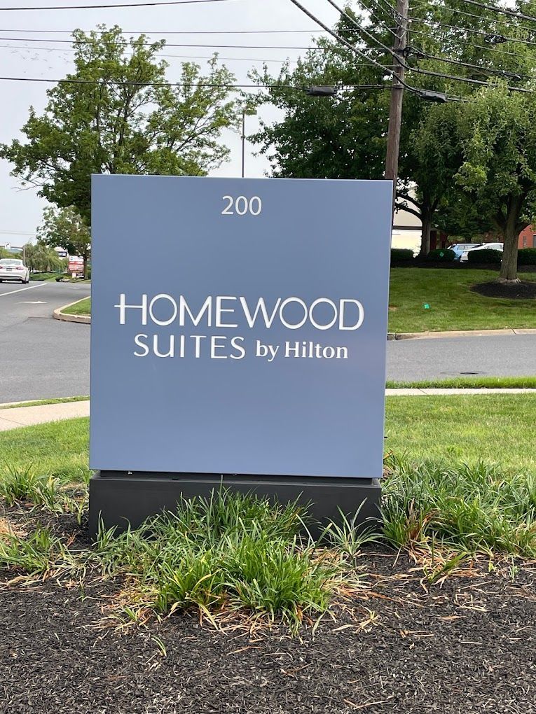 A blue sign for homewood suites by hilton