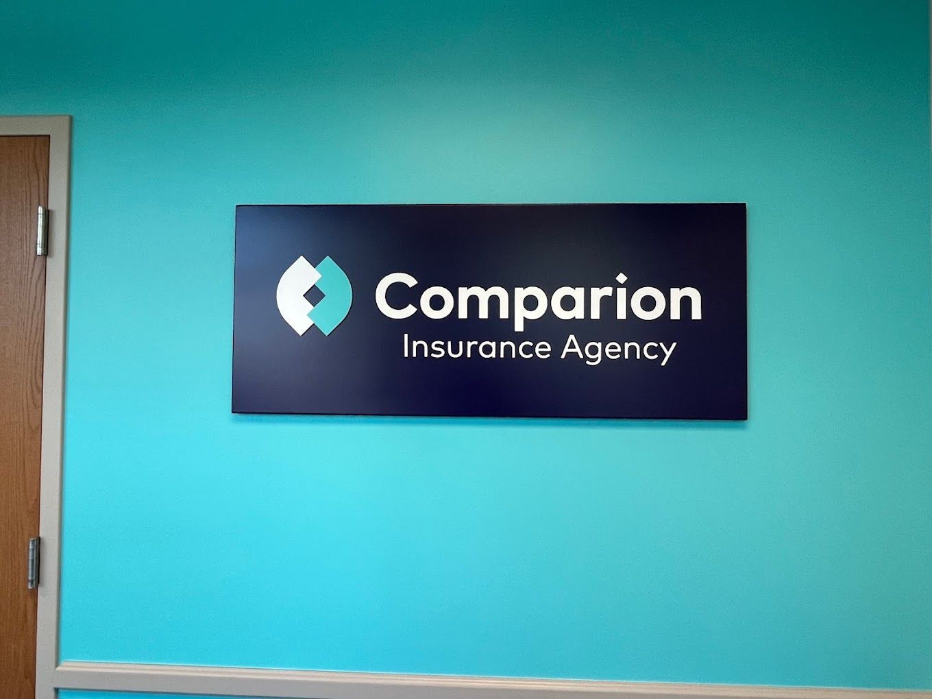 A blue wall with a sign that says companion insurance agency