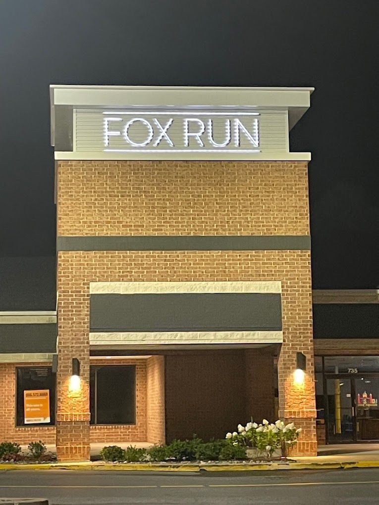 A brick building with a sign that says fox run