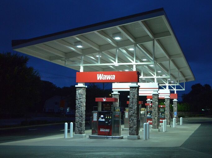 A wawa gas station is lit up at night