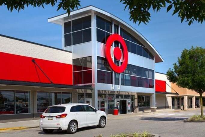 A white car is parked in front of a target store