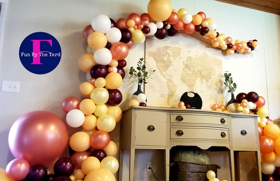 A room decorated with balloons and a map on the wall.