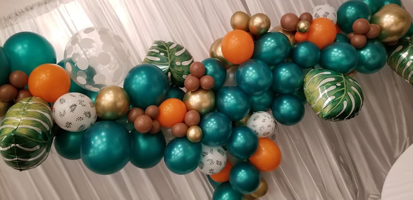 A free from balloon garland with leaves in green and orange