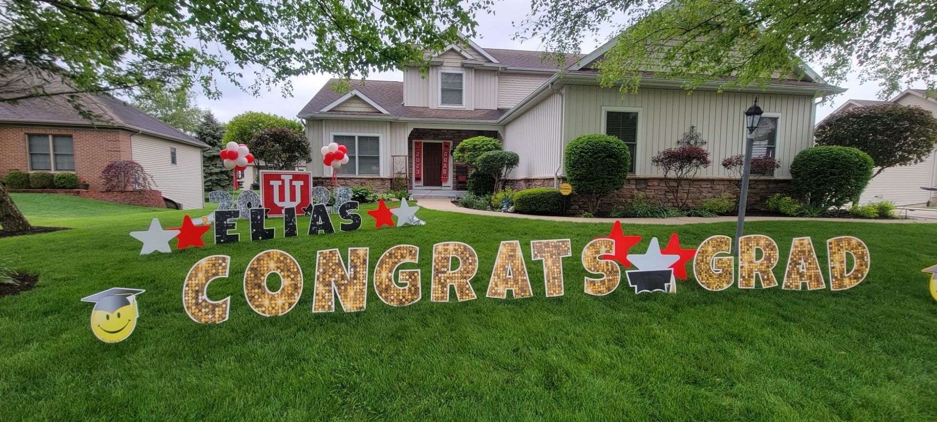 A house with a congratulations grad sign in front of it.