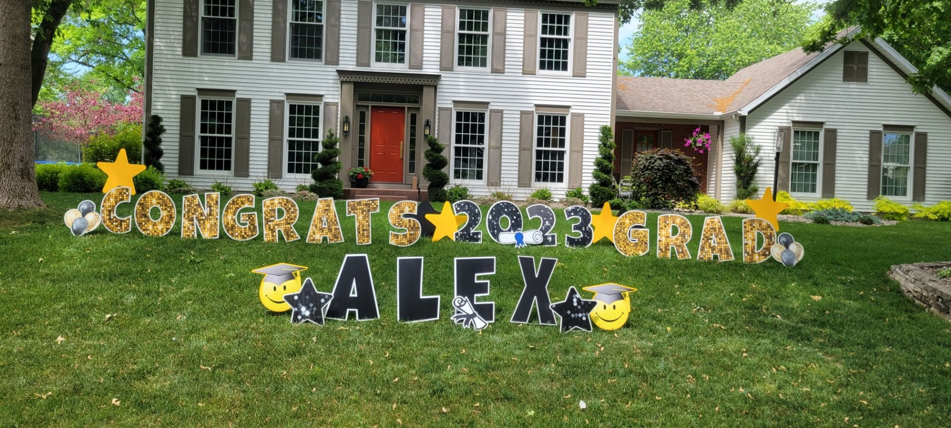 A house with a congratulations sign in front of it.