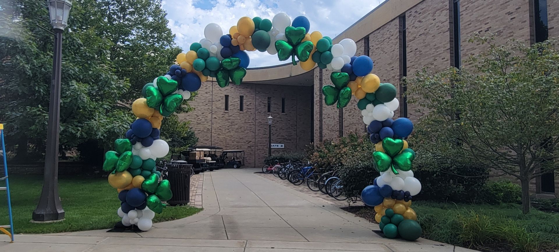 Notre Dame balloon arch at the joyce. blue green gold white. fun by the yard.
