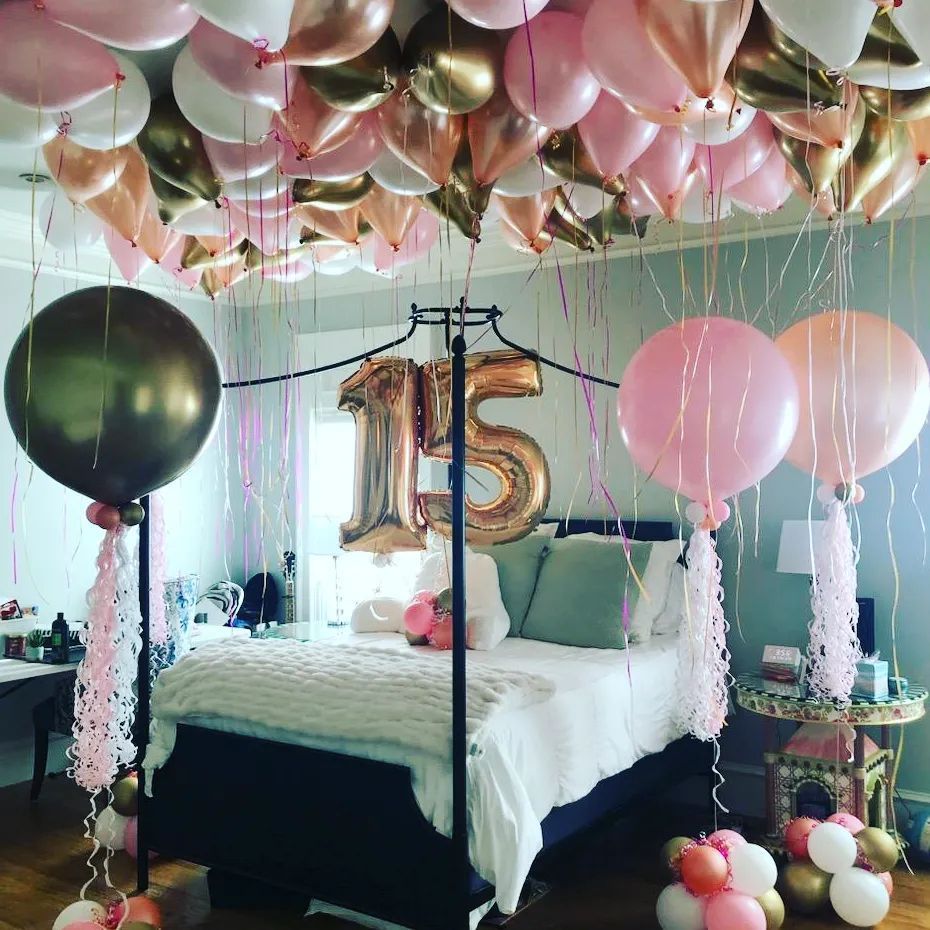 A bedroom decorated with balloons and a number 15 balloon. Party Bomb