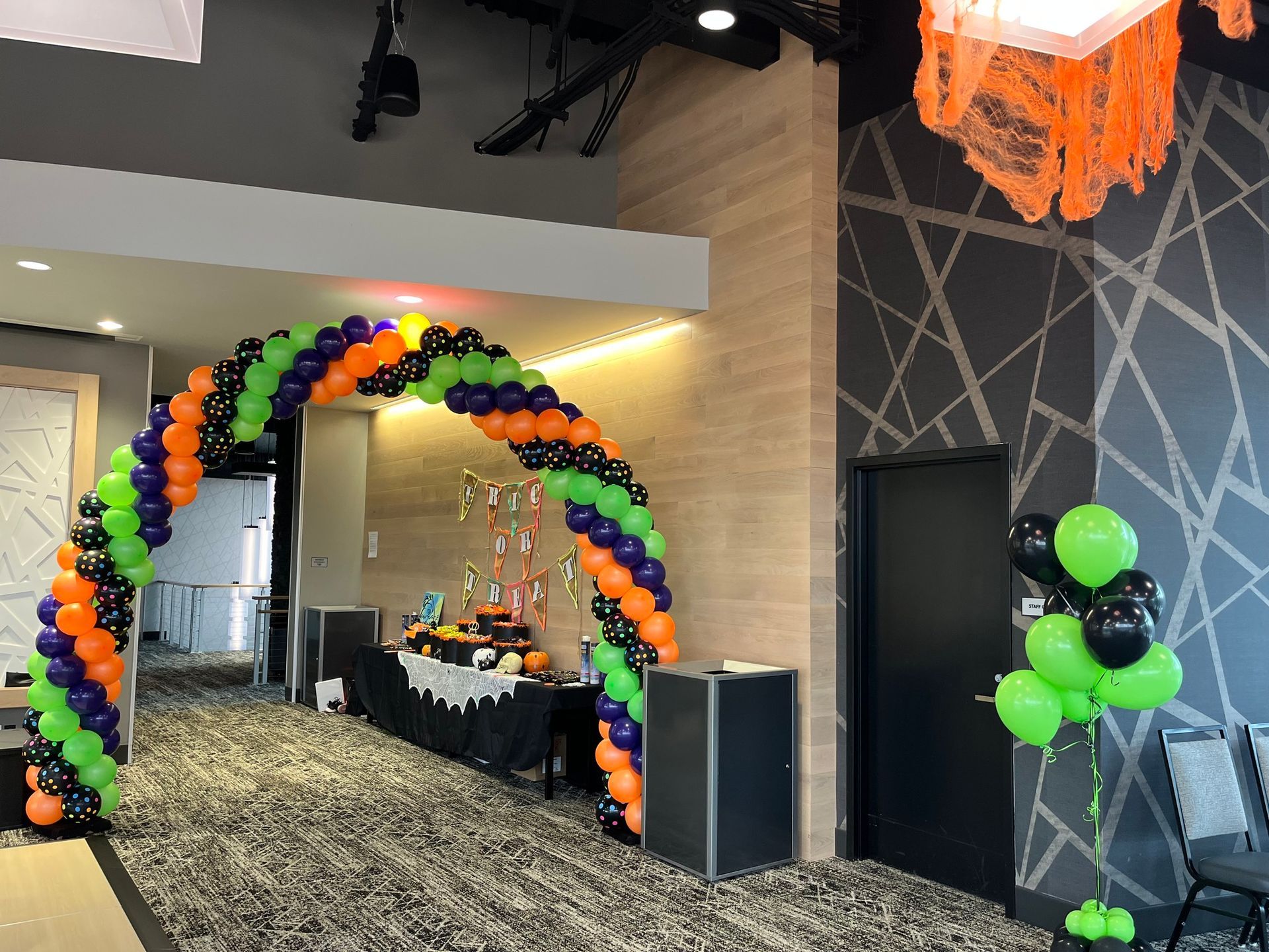 A room decorated with balloons for a halloween party.