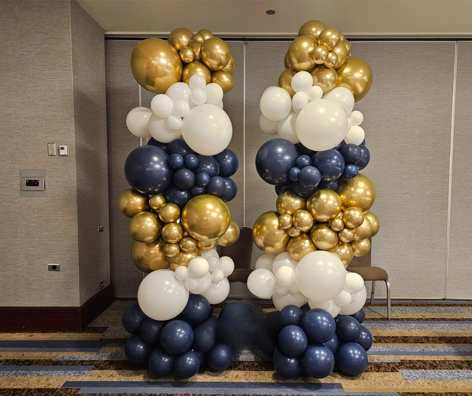 A bunch of balloons are stacked on top of each other in a room.