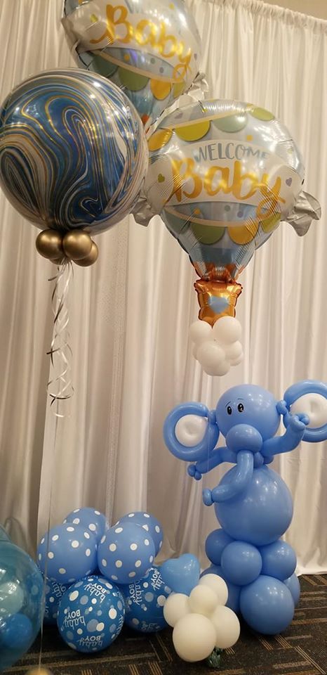 A bunch of balloons are sitting on top of each other on a table.