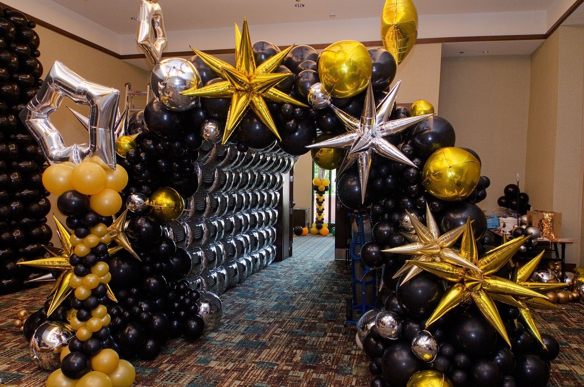 New Years Ever welcome arch. Star bursts. Organic garland. Foil balloon squares.