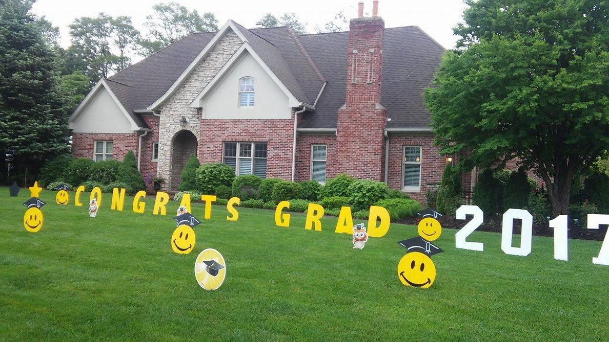 A house with a congratulations grad sign in front of it