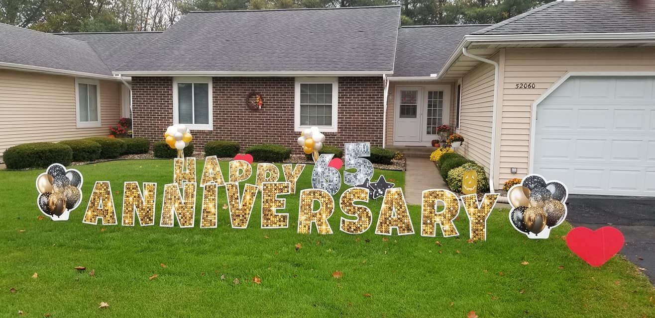 A house with a sign in front of it that says `` anniversary ''.
