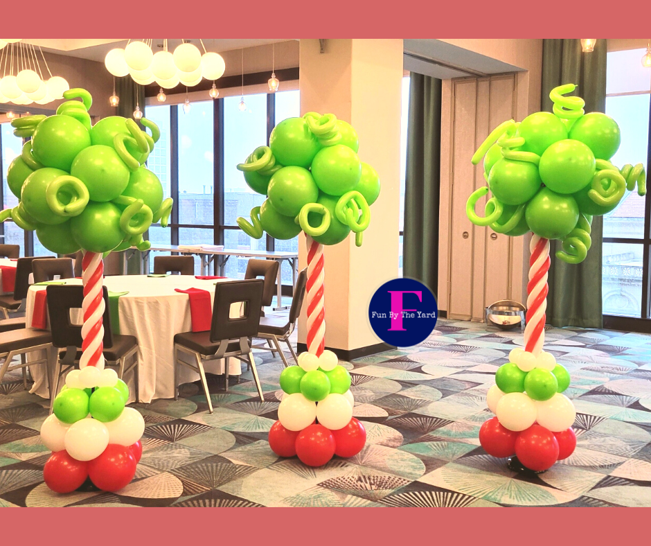 A room decorated with balloons in the shape of trees and candy canes.  Dr. Suess