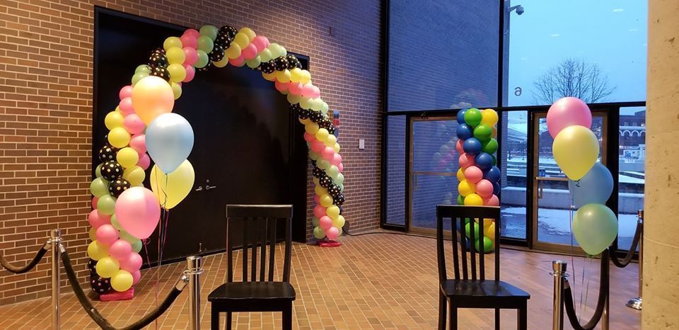 A room with chairs and balloons in it