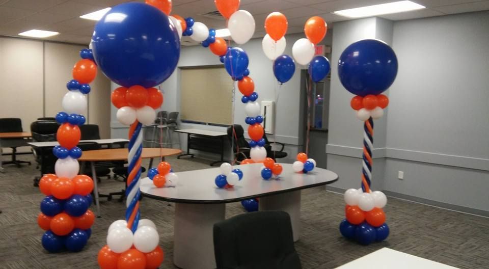 A room decorated with blue and orange balloons