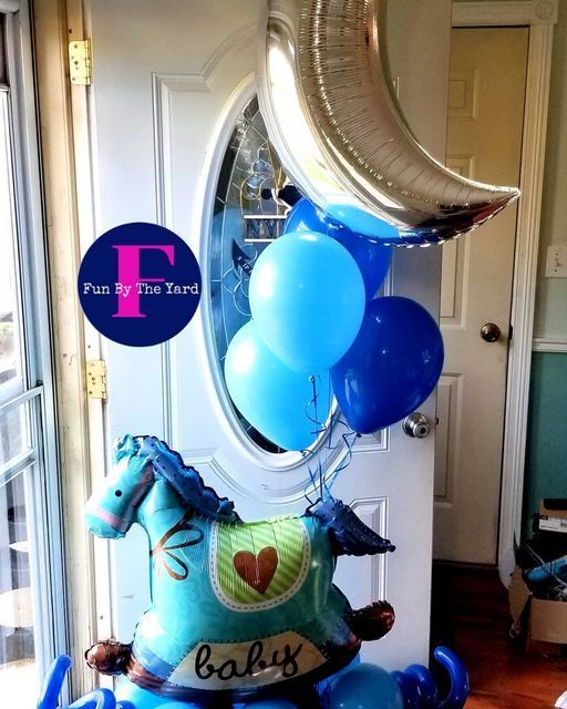 A rocking horse balloon with the word baby on it