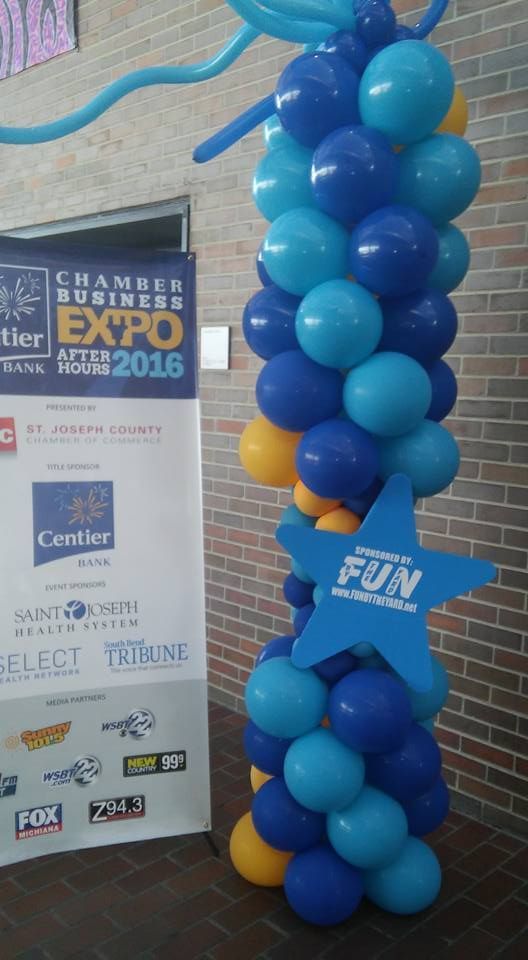 Blue and yellow balloons with a blue star that says fun by the yard.