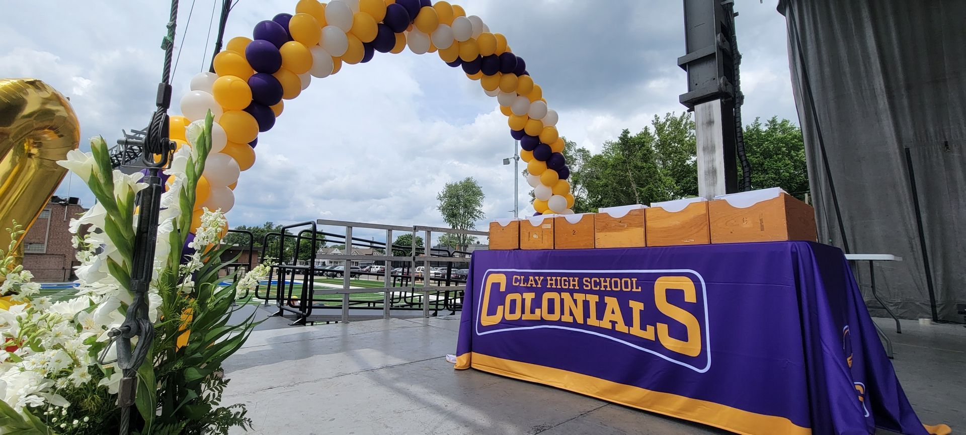 A purple table cloth with the word colonials on it