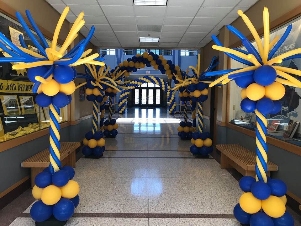 A hallway decorated with blue and yellow balloons