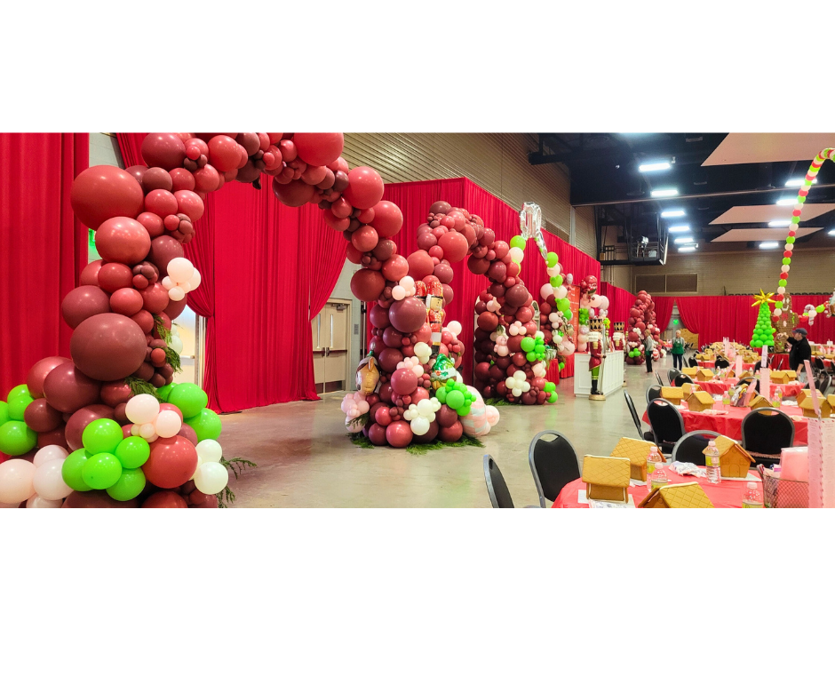 Archway of red and brown balloons, Christmas event in a hall.