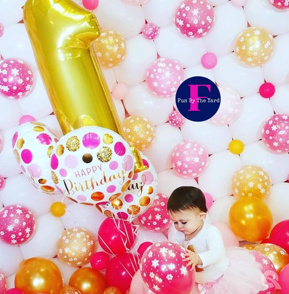 Baby with balloons; gold