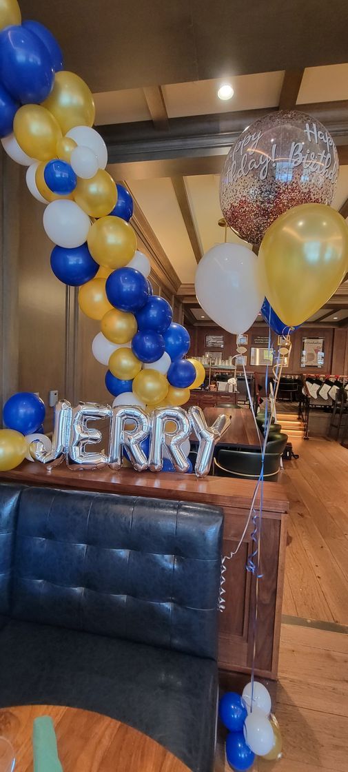a restaurant is decorated with balloons and a sign that says merry