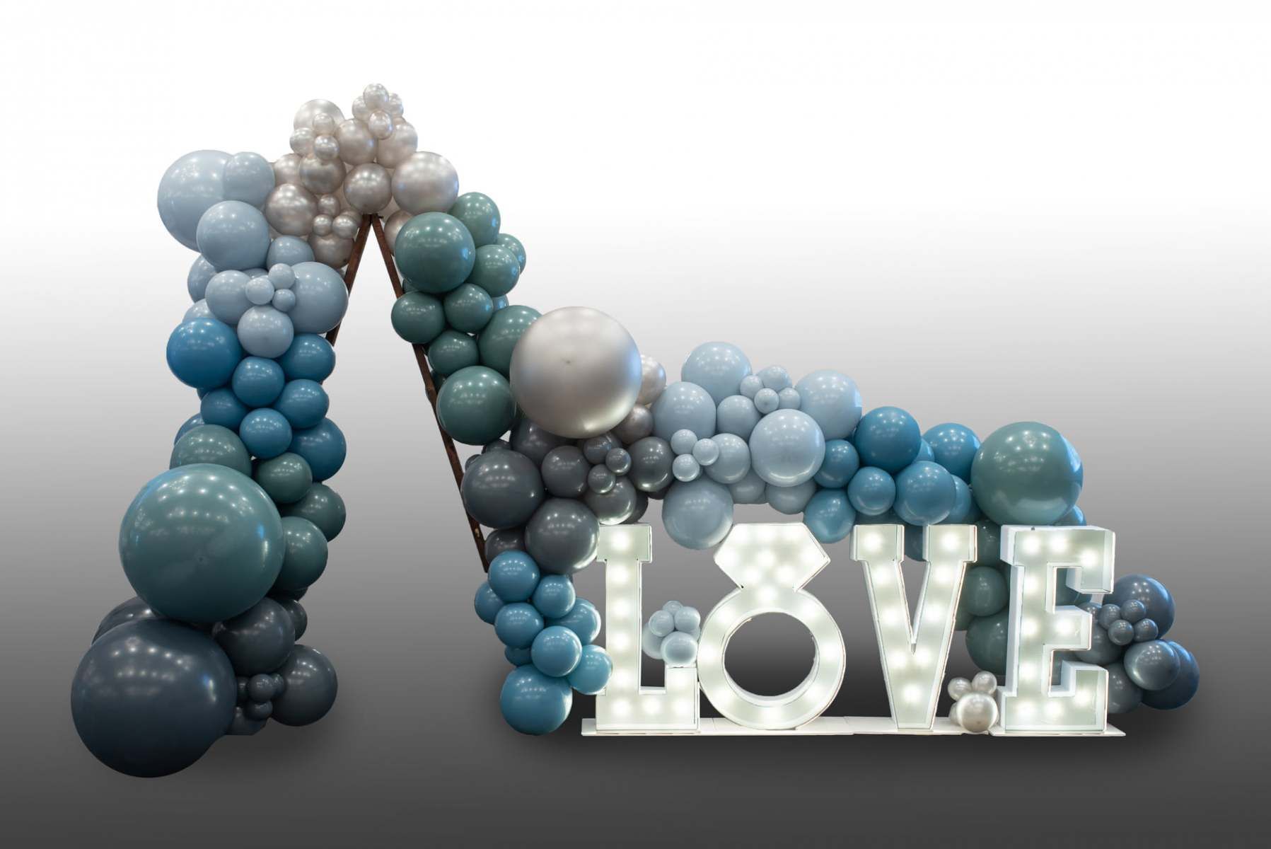 The word love is made of balloons and lights.