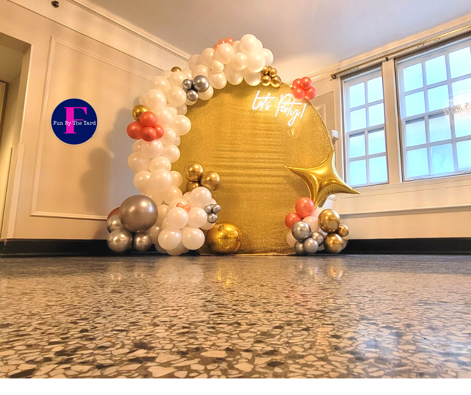 A room filled with balloons and a sign that says let 's party.