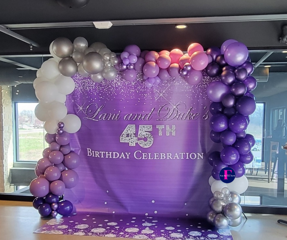 Purple and silver balloon arch with backdrop for Lani and Duke's 45th birthday celebration.
