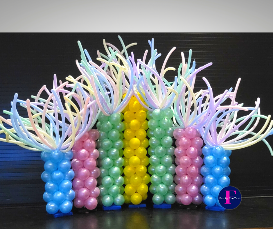 A bunch of colorful balloons are stacked on top of each other