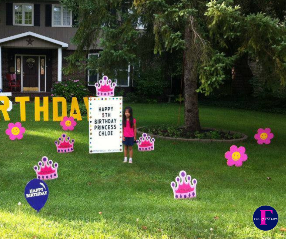 a girl stands in front of a birthday sign
