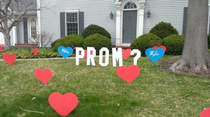 A sign that says prom in front of a house