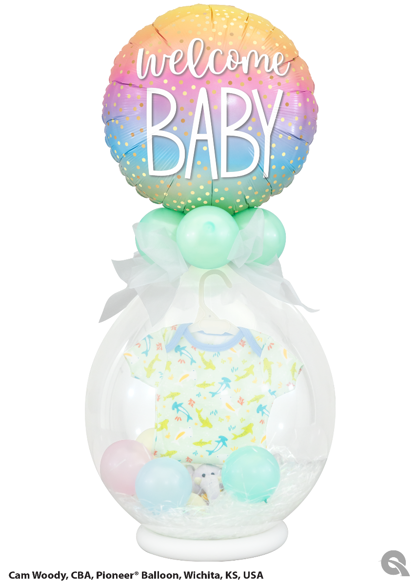 Baby shower balloon arrangement with a onesie inside a clear orb.
